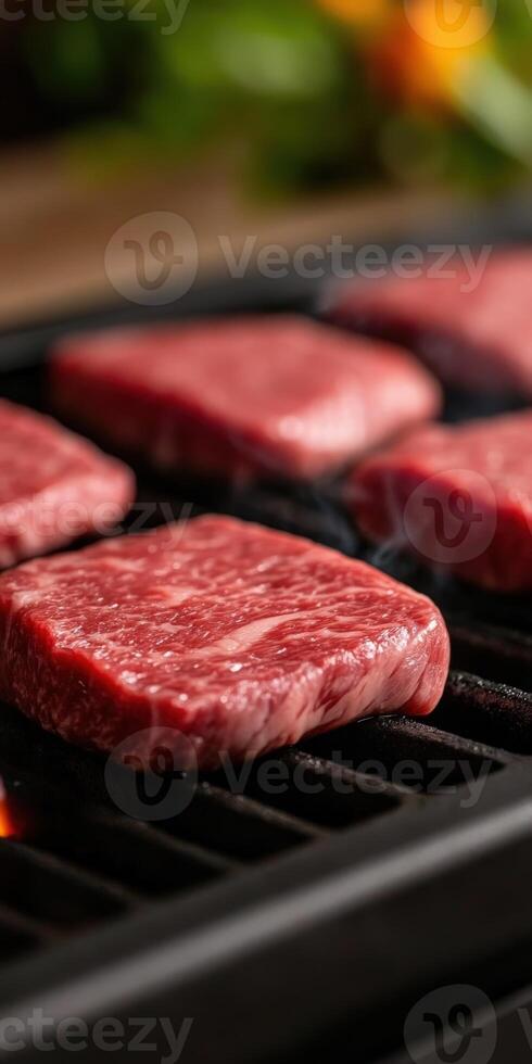 Grilling fresh beef steaks on a barbecue during summer cookout photo