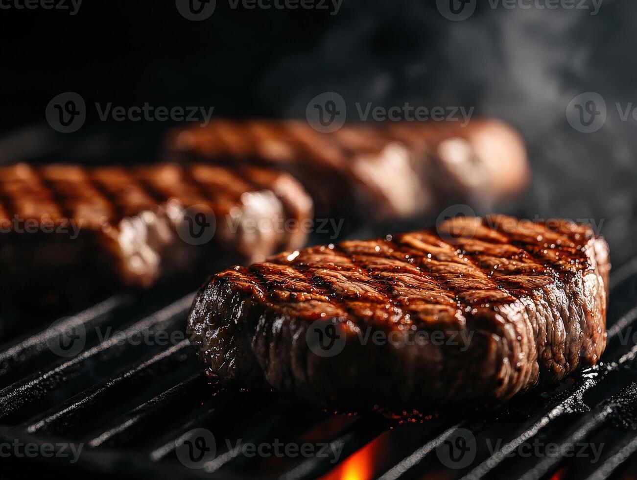 Perfectly grilled beef steaks sizzling on a barbecue grill in the evening photo