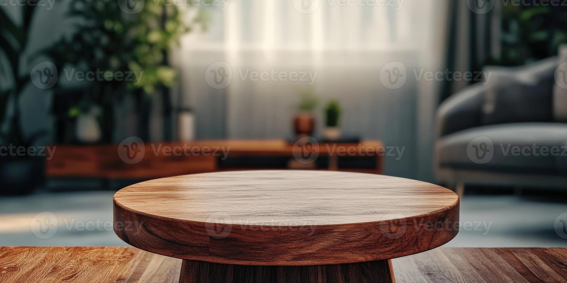 A wooden coffee table in a sunlit living room with plants and couch photo