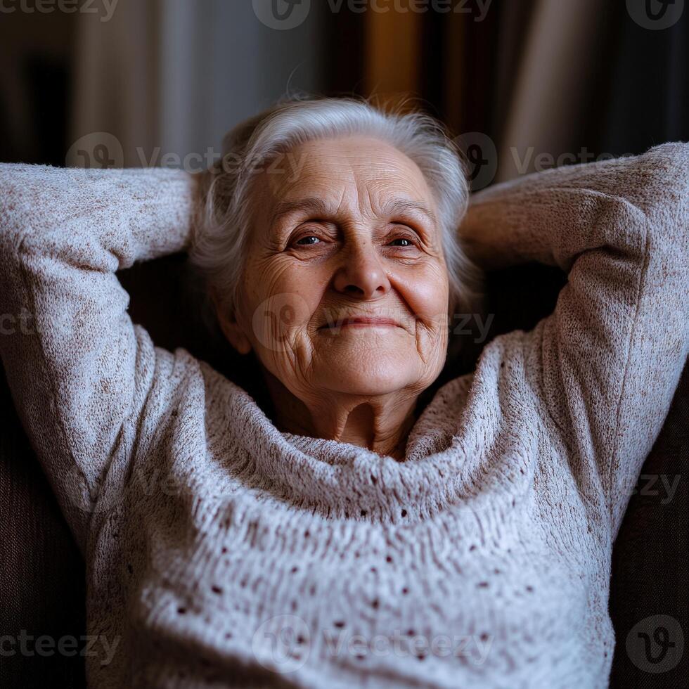 Elderly woman relaxing on a sofa at home during the afternoon photo