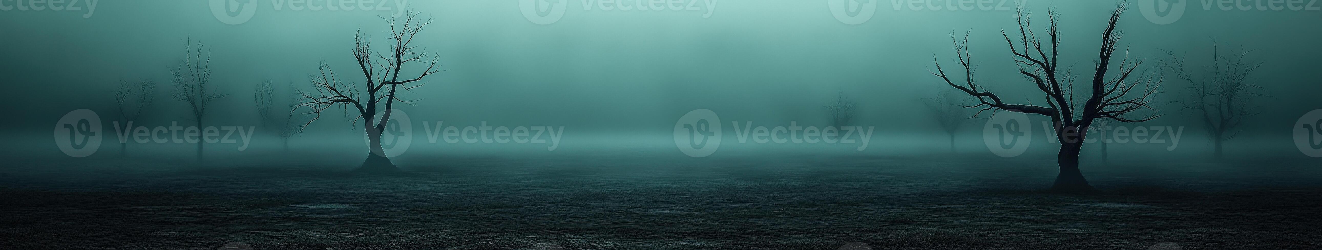 Foggy landscape with barren trees in twilight hours photo