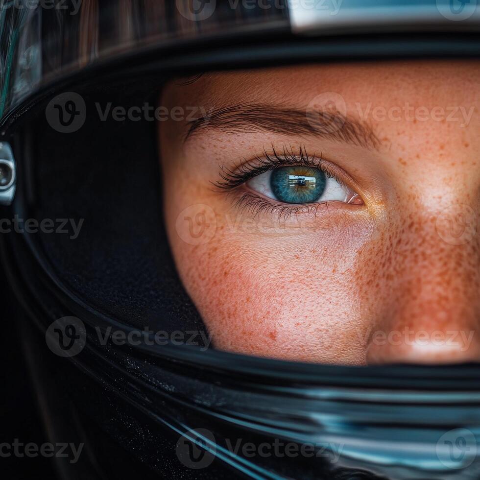 A close-up of a racer eye behind a black helmet during a race photo