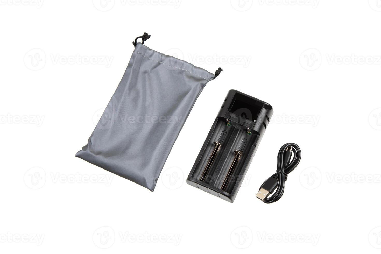 Battery charger set with a dual-slot charger, USB cable, and gray drawstring pouch, perfect for portable and convenient battery charging. Isolated on a white back. photo