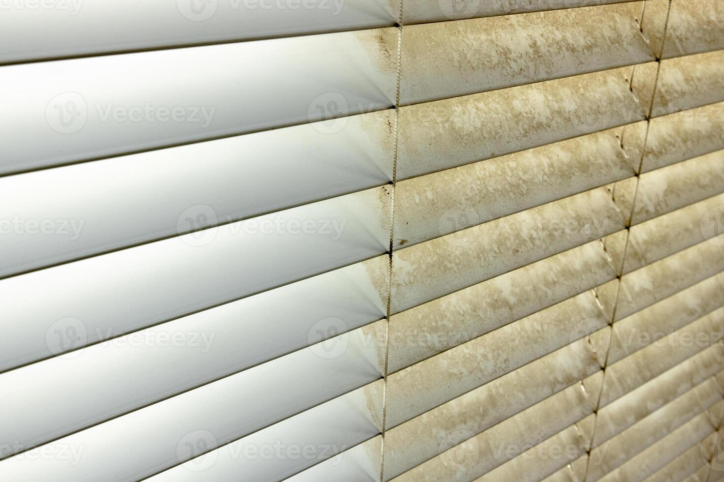Residential Window Shades Showing the Before and After of a Good Cleaning - One Side Clean and One Side Dirty. photo