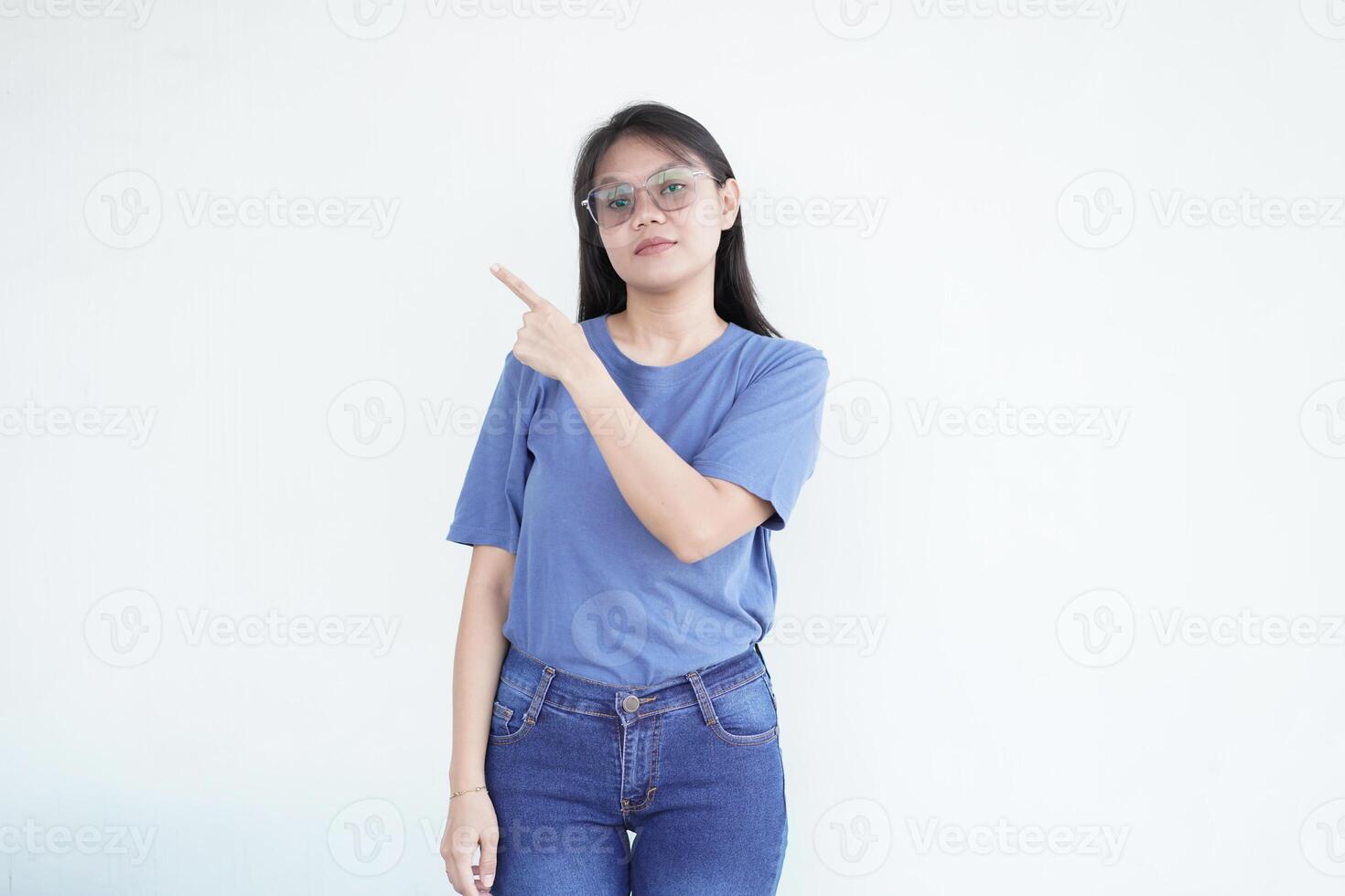 beautiful Asian woman makes a pointing gesture with her fingers, set against a clean white background photo
