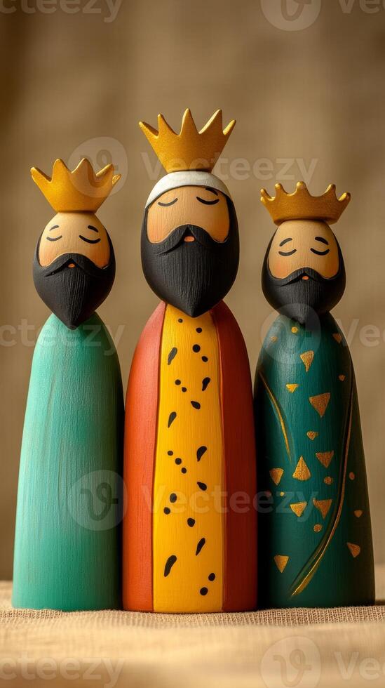 Charming wooden figurines of the Three Kings with simple golden crowns. Epiphany vertical image photo