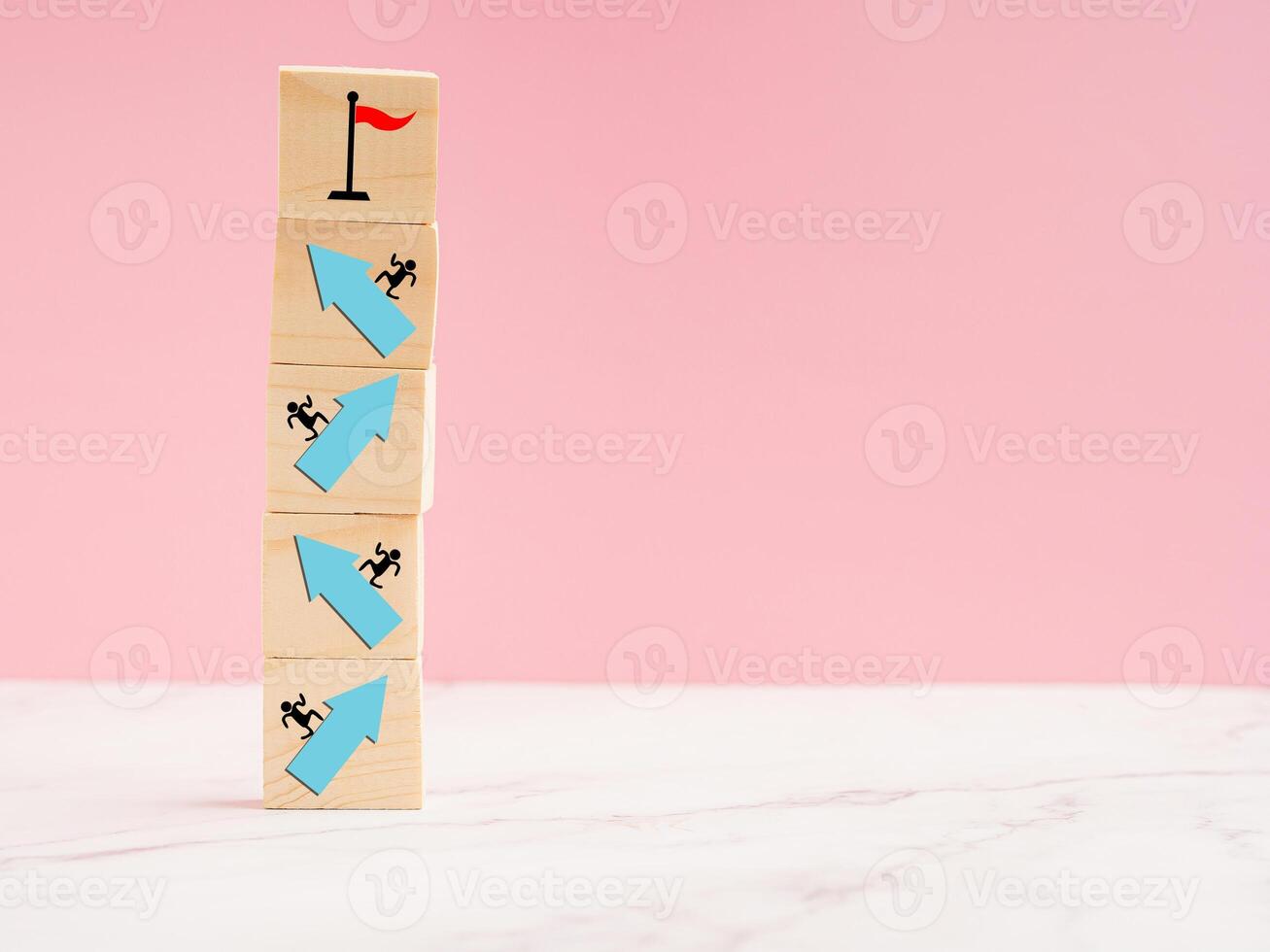 Wooden cubes with blue arrow up a point on a marble floor over a light blue background photo