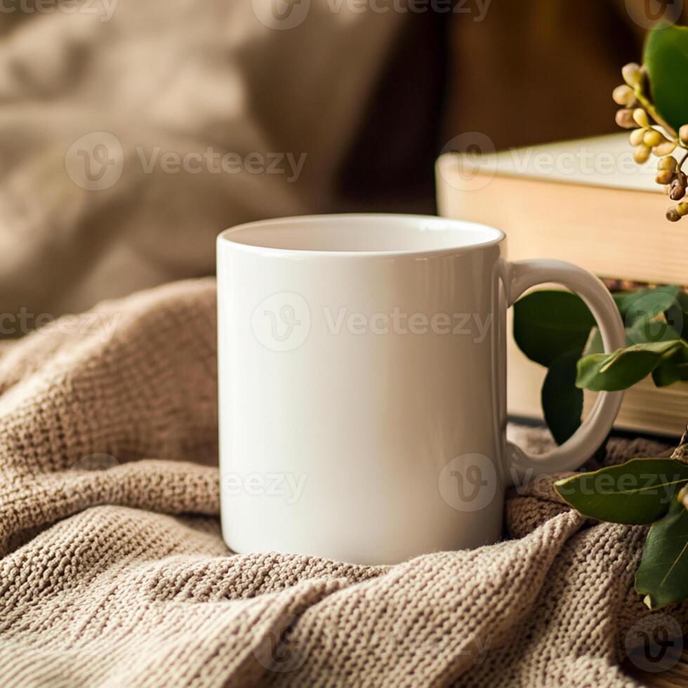 A white mug and a book on a blanket photo