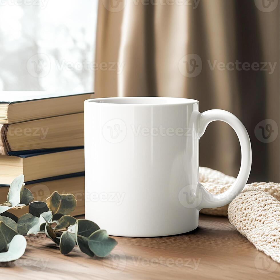 A mug and books on a table with a window photo