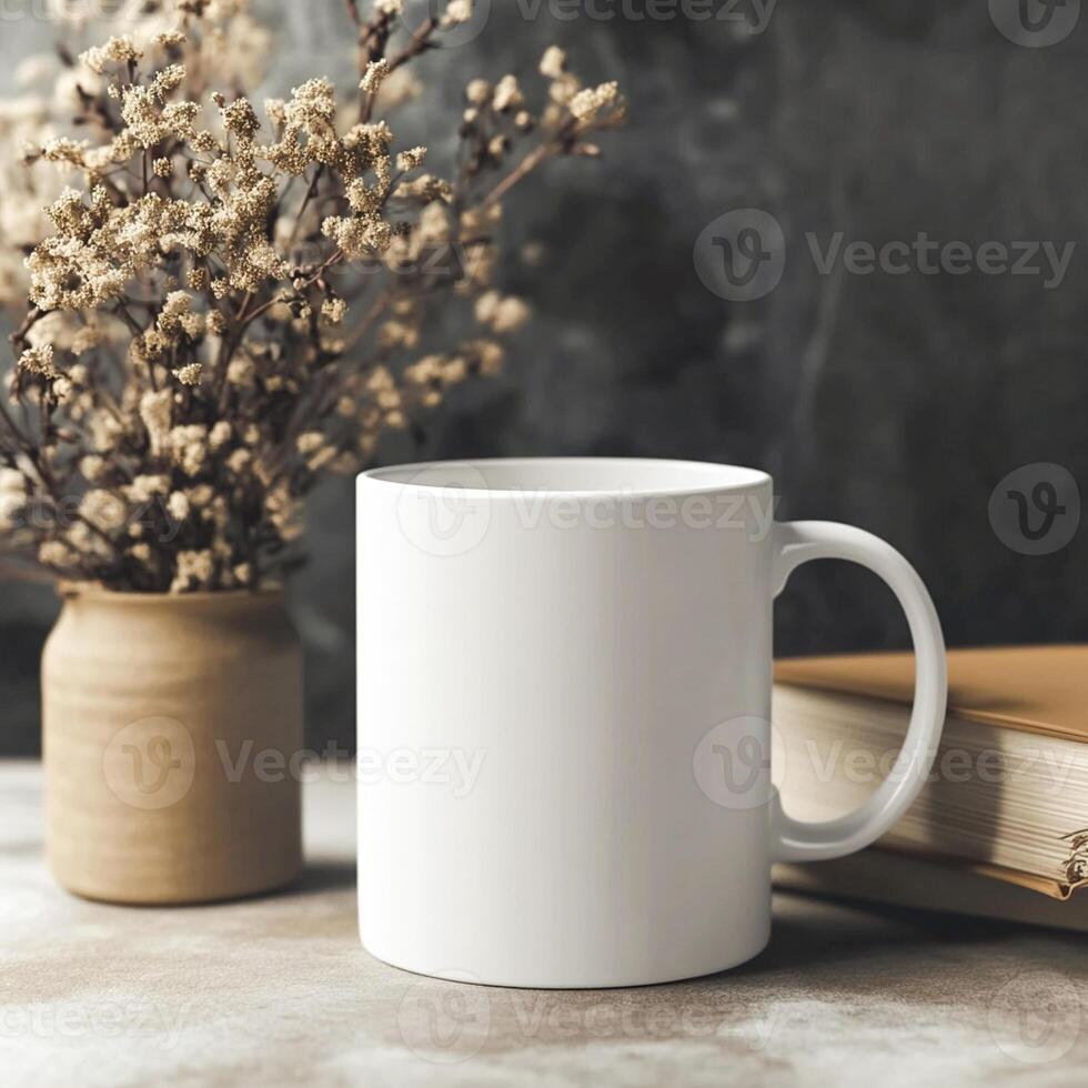A white mug and books on a table photo