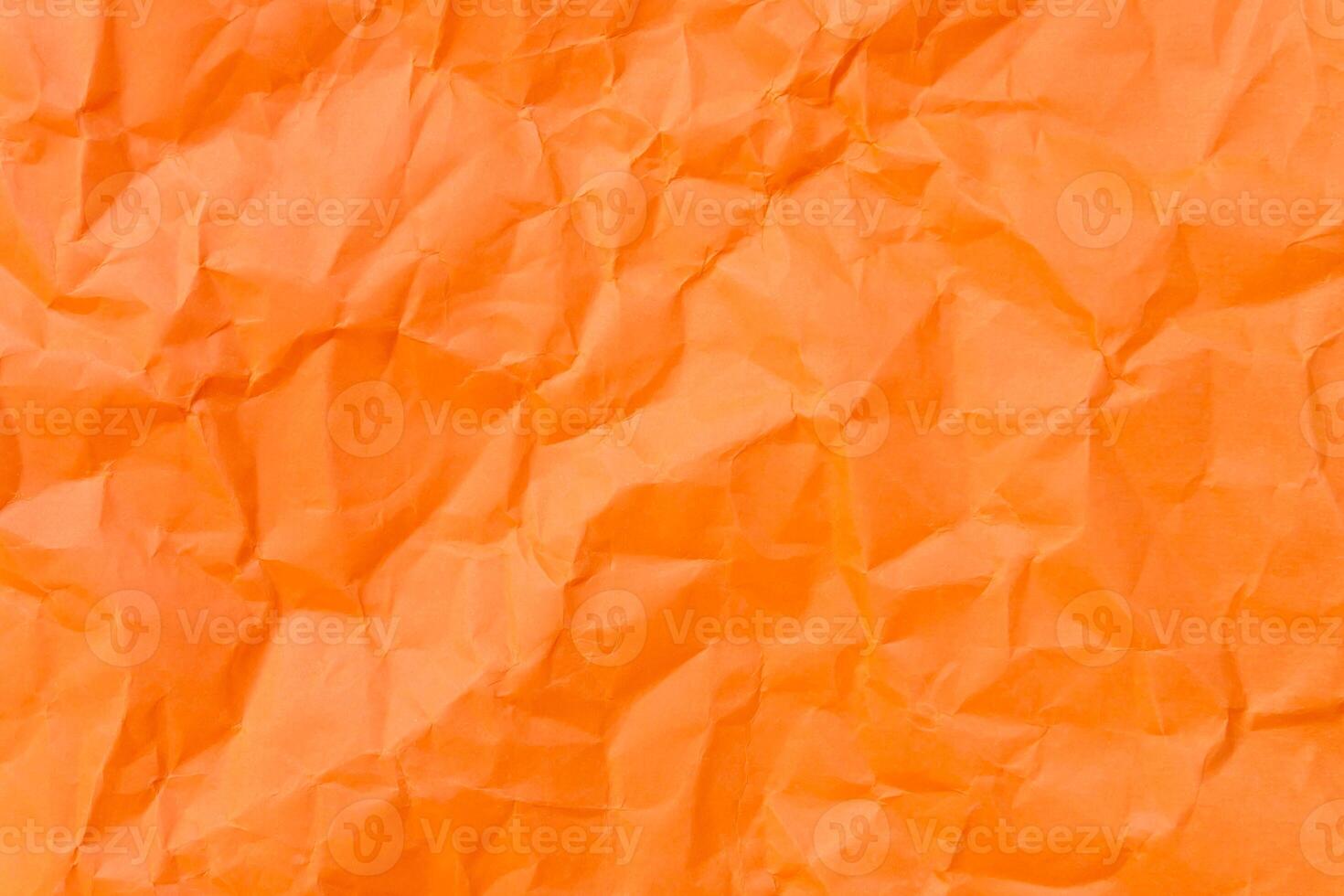 Top view and full frame of wrinkled or crumpled orange paper used as crumpled orange paper background texture. photo