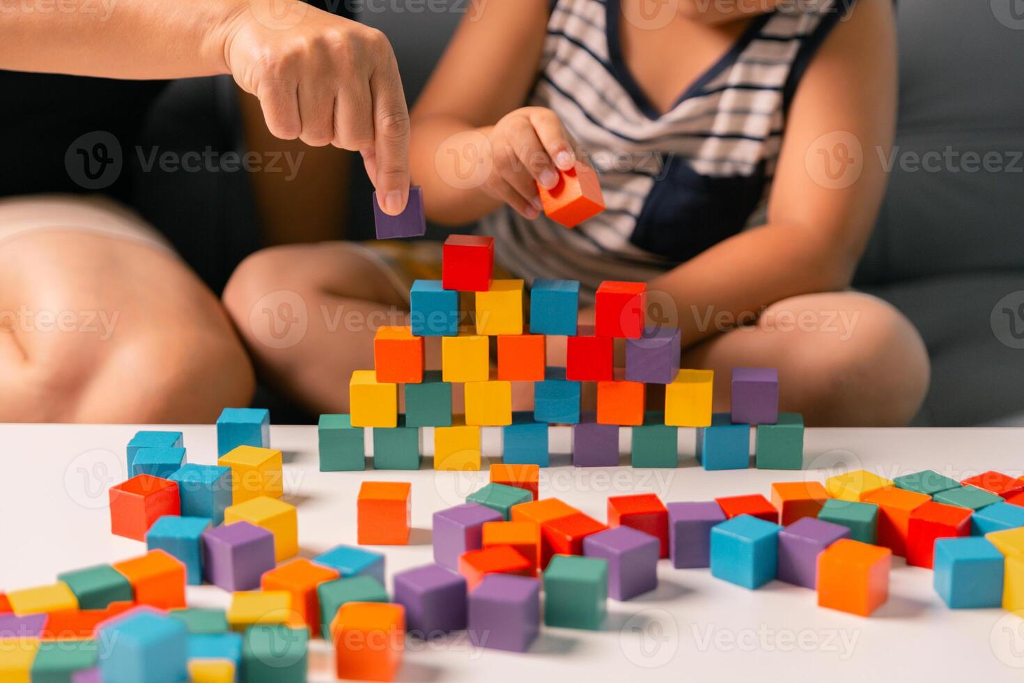Children enjoy colourful game with educational toy blocks that make play fun activity, enhancing their development during childhood. gathering, creation, exercise, inspiration, improvement, practice. photo
