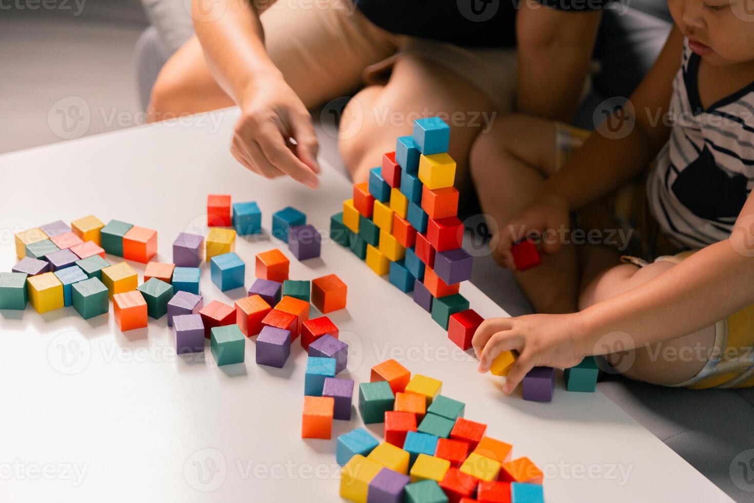 Children enjoy colourful game with educational toy blocks that make play fun activity, enhancing their development during childhood. gathering, creation, exercise, inspiration, improvement, practice. photo