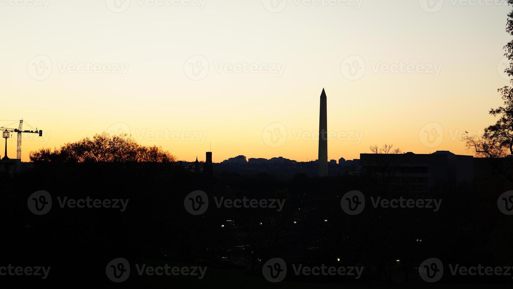 The beautiful sunset city view with the silhouette of the monument tower in Washington DC photo