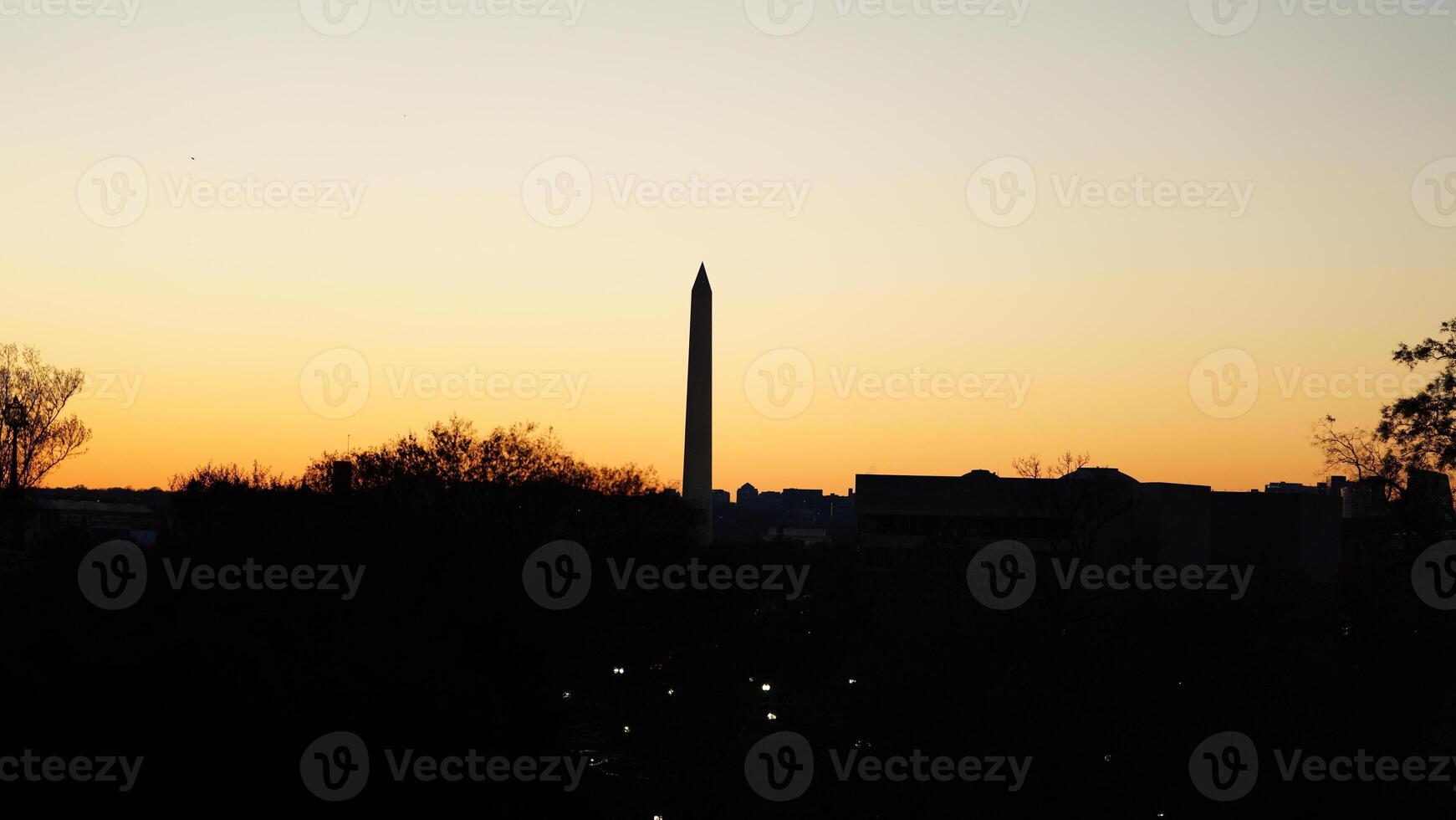 The beautiful sunset city view with the silhouette of the monument tower in Washington DC photo
