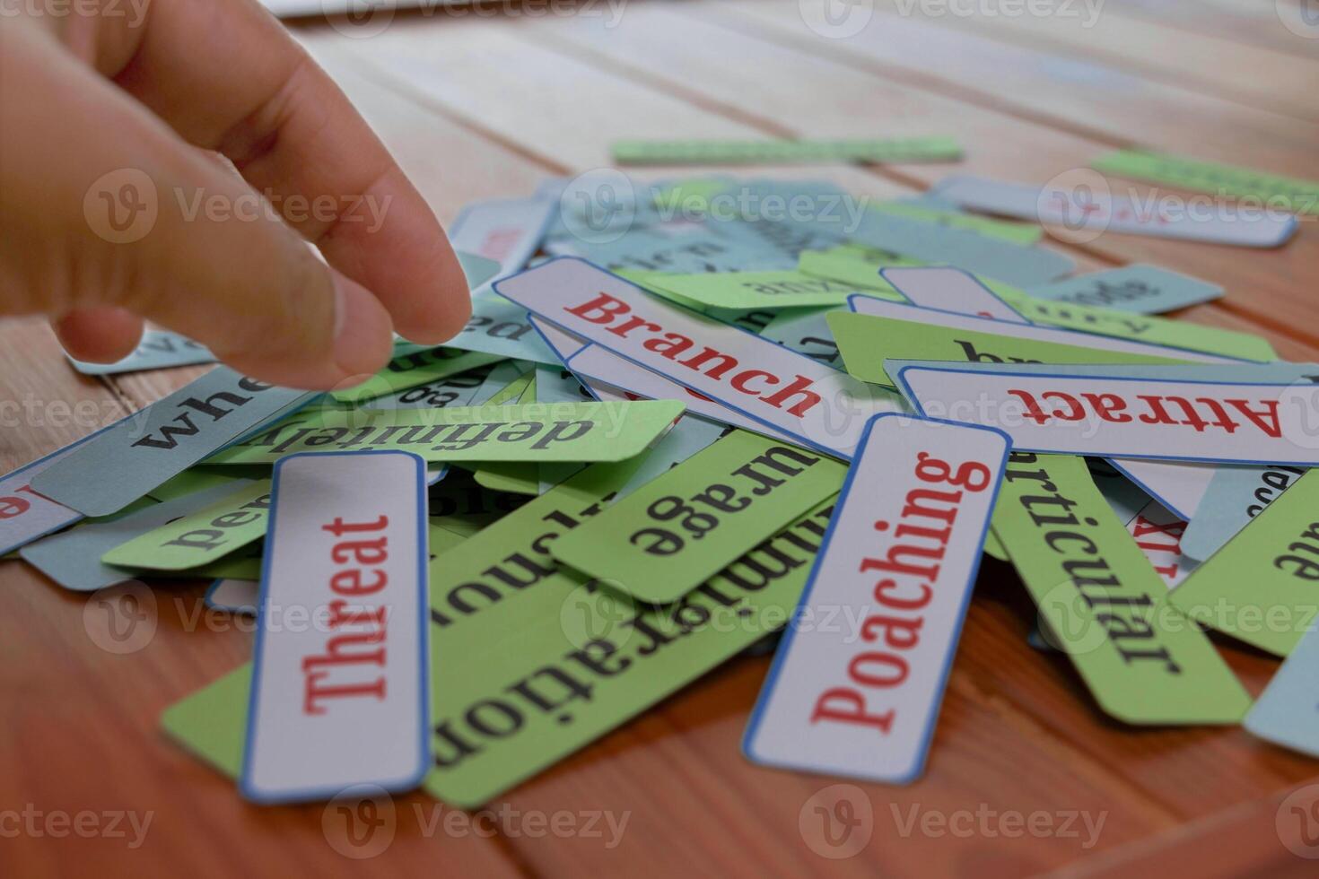hand picking up cards in class photo