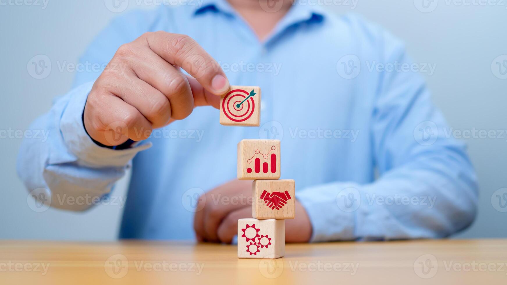 Wood block stacking arranged by a hand, representing a business strategy and Action plan. Targeting the concept of procedure and systematic work approach,Targeting the business concept. photo