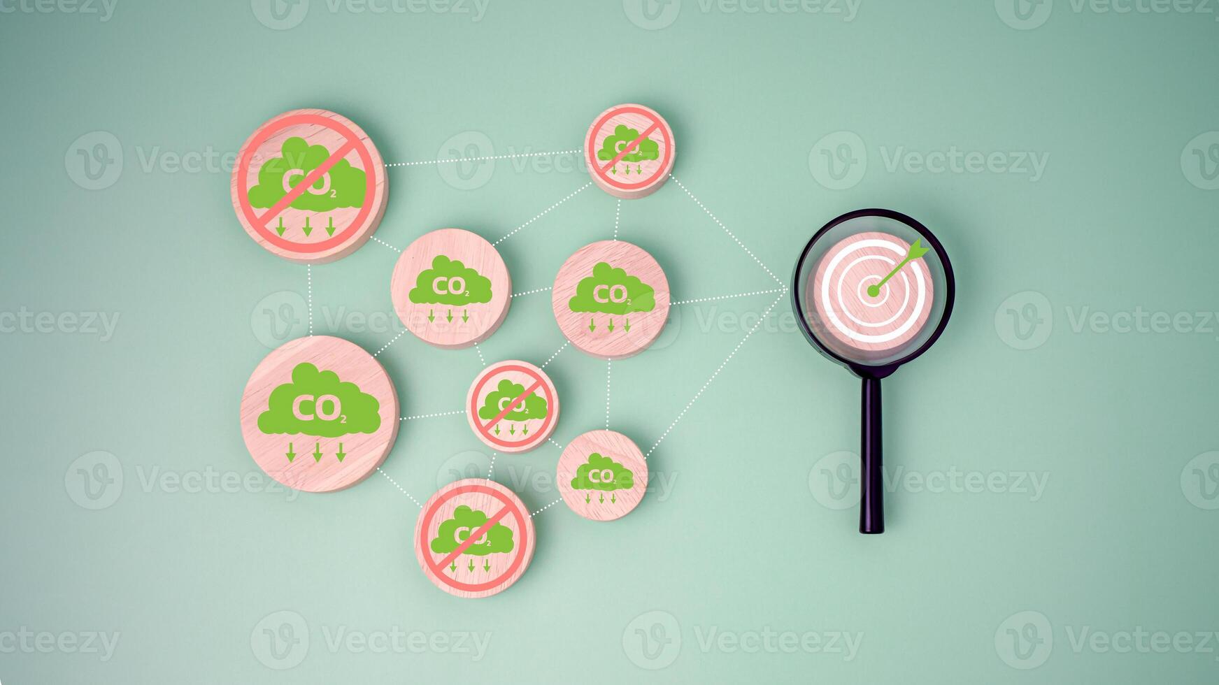 CO2 reducing icon on Circular wooden plate Connect with Target board icon inside magnifying glass for focusing decrease carbon dioxide emission target, Carbon footprint and carbon credit concept. photo