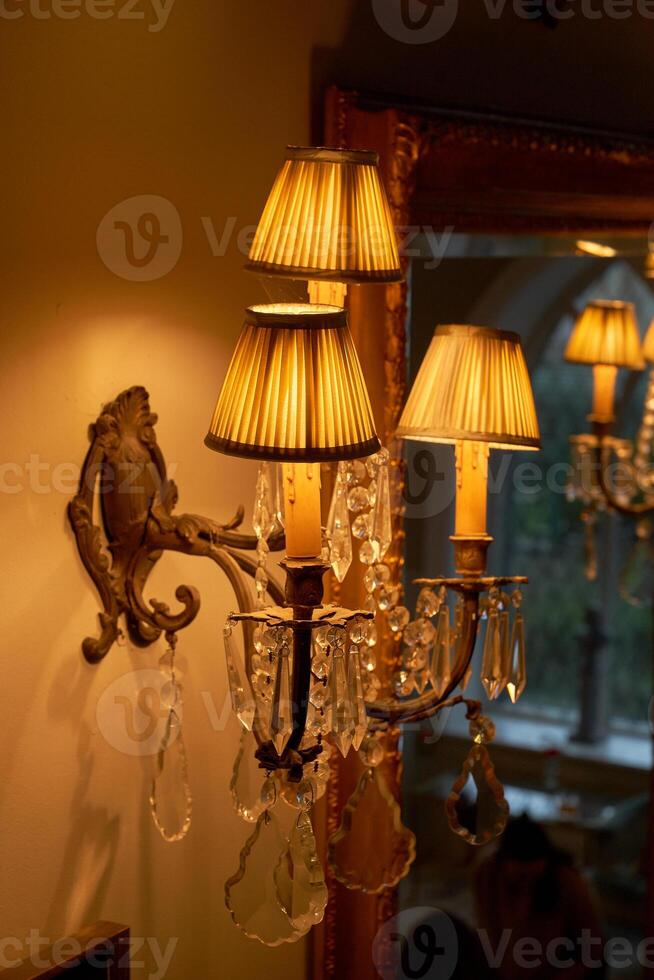 Splendid chandelier with lit candles in a beautiful room of an old mansion photo