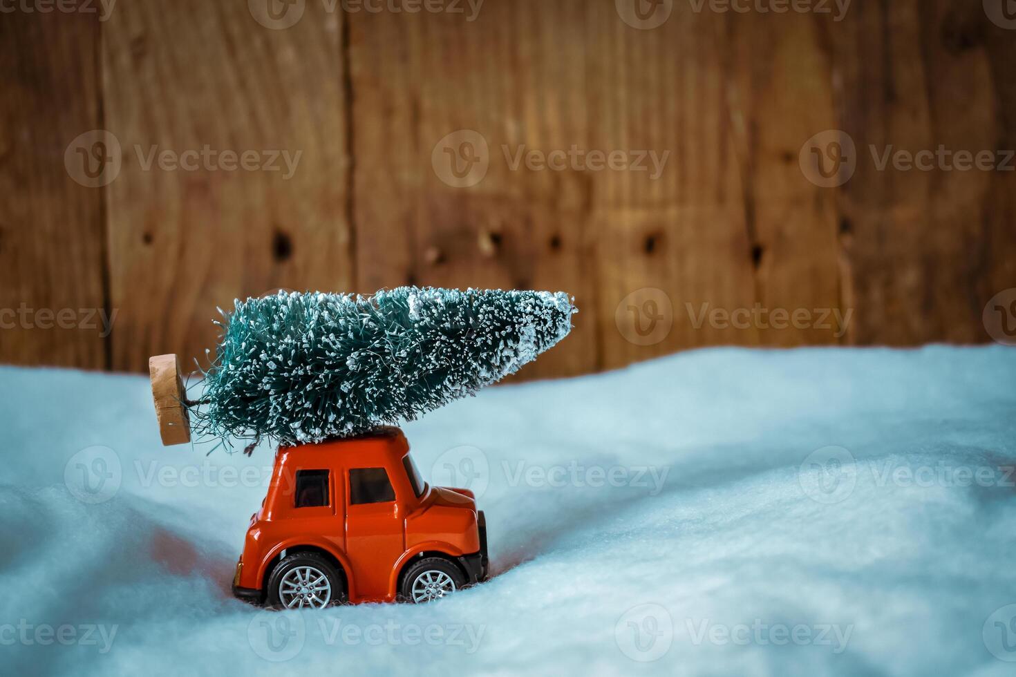 Red toy car with a christmas tree on the roof photo