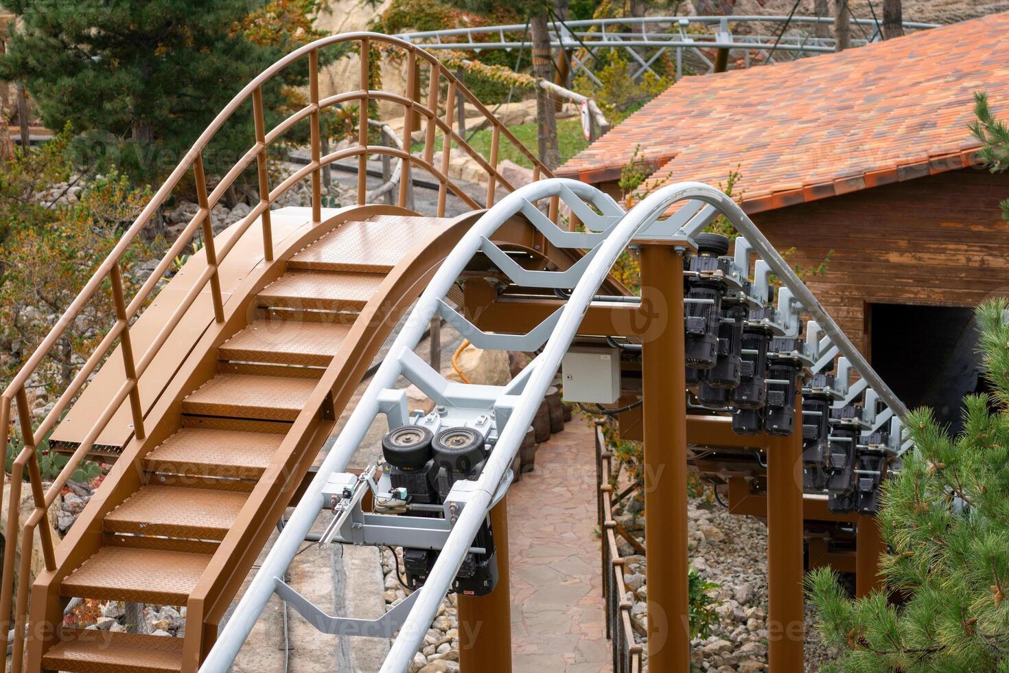 Rollercoaster Track Stairs Wooden Structure - A close-up of a wooden rollercoaster track with stairs and a wooden structure in the background. photo