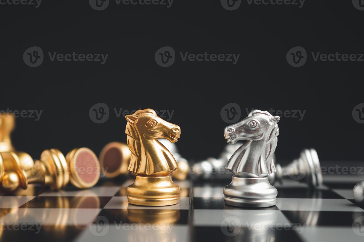 Chess pieces on board game planning and competition on black background photo
