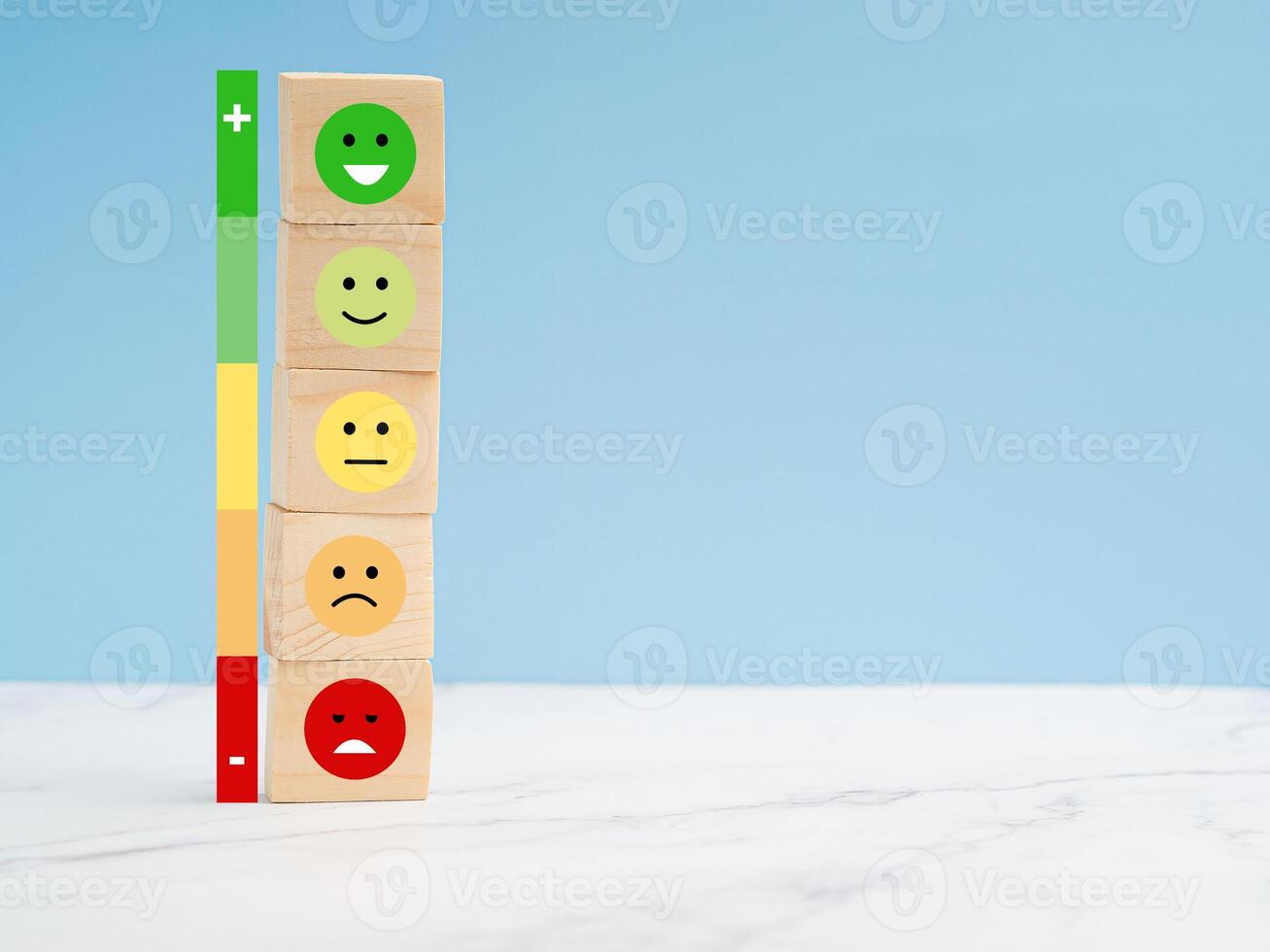 Customer experience, satisfaction, feedback, and services rating concept. Wooden cubes with sad and happy mood icons photo