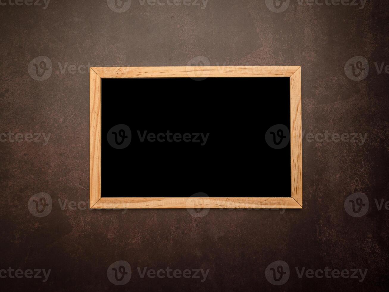 Top view of empty blackboard with a wooden frame over a vintage background photo