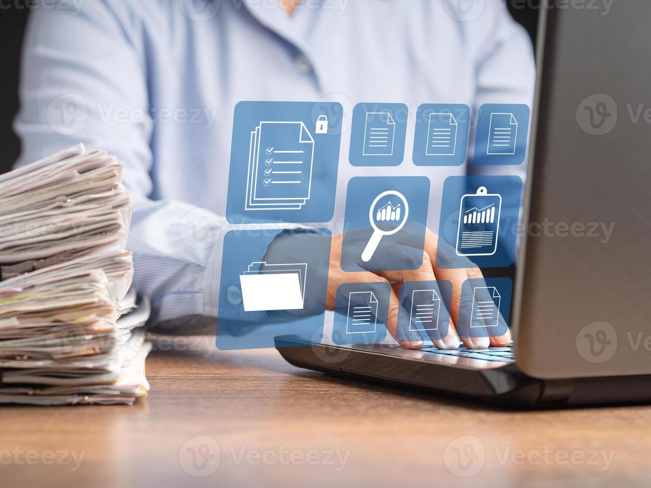 Businessman working at a laptop and digital documents on a virtual screen photo