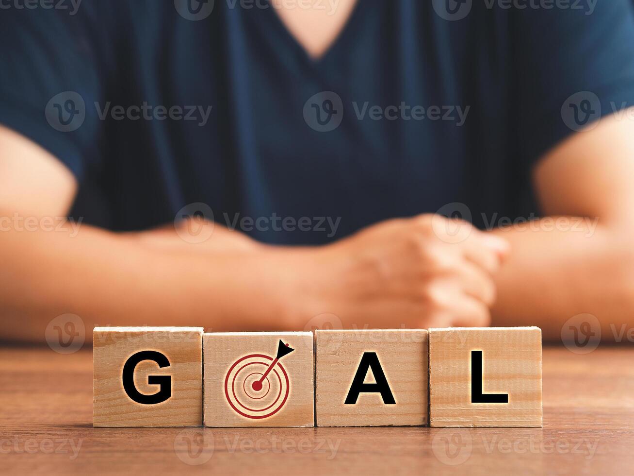 Business and goal concept. Wooden cubes with the letters G, A, L, and target icon on a wooden table photo