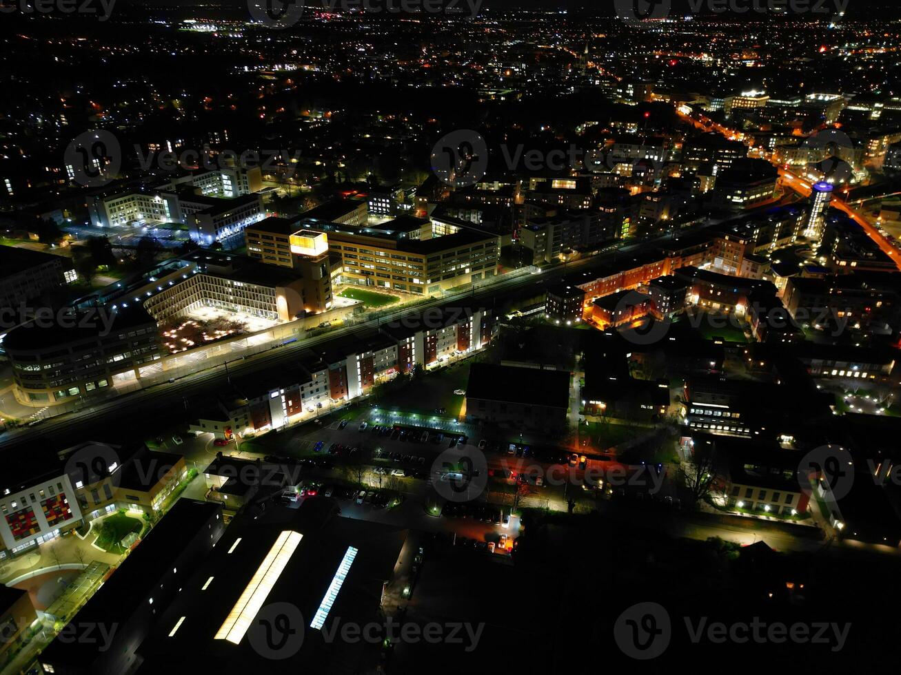 Aerial View of Illuminated Central Cambridge City of Cambridgeshire of England UK During Night. High Angle Footage Was Captured with Drone's Camera at Just After Sunset on March 22nd, 2024 photo