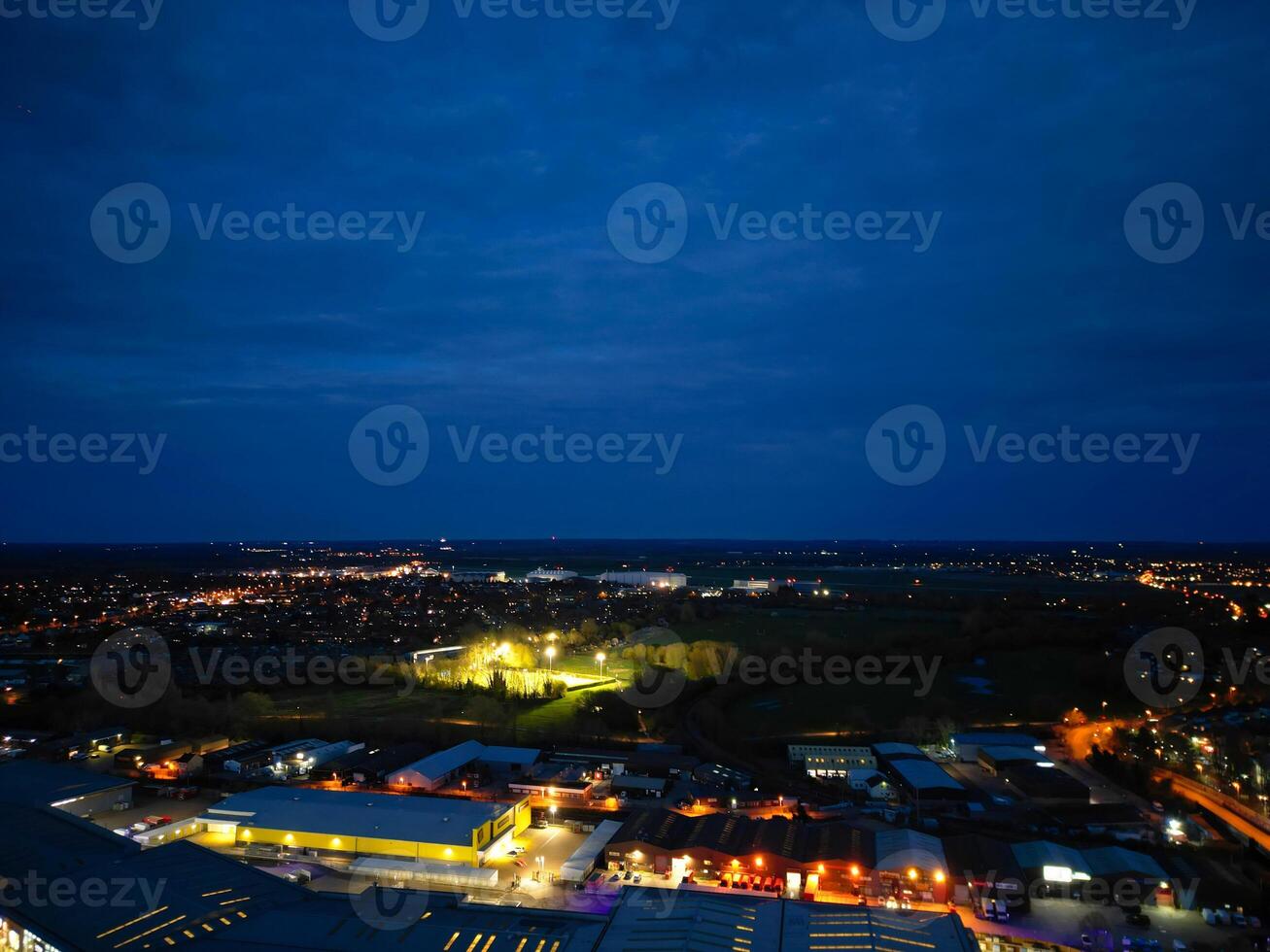 Aerial View of Illuminated Central Cambridge City of Cambridgeshire of England UK During Night. High Angle Footage Was Captured with Drone's Camera at Just After Sunset on March 22nd, 2024 photo