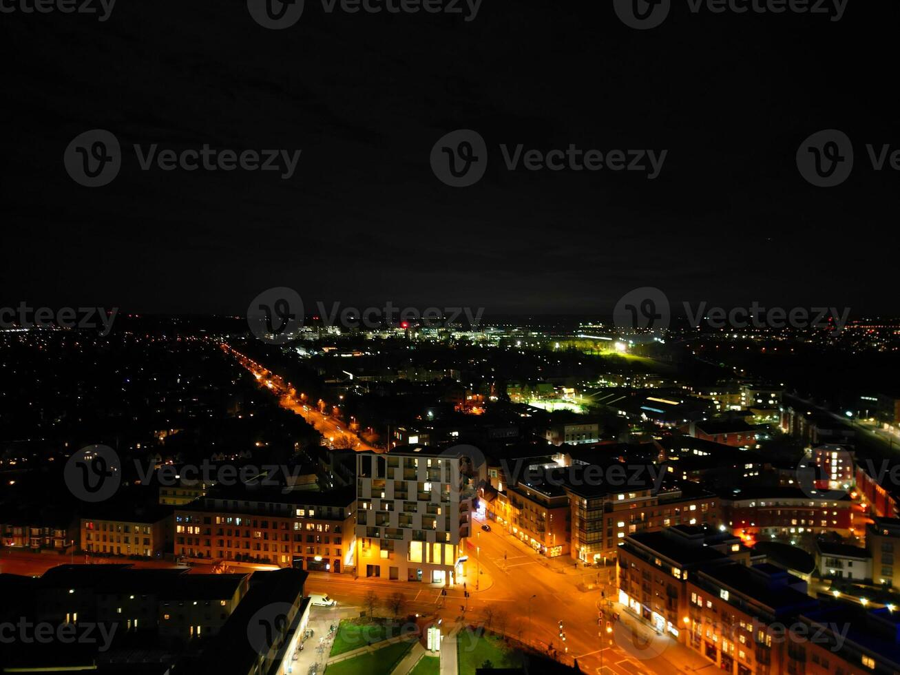 Aerial View of Illuminated Central Cambridge City of Cambridgeshire of England UK During Night. High Angle Footage Was Captured with Drone's Camera at Just After Sunset on March 22nd, 2024 photo