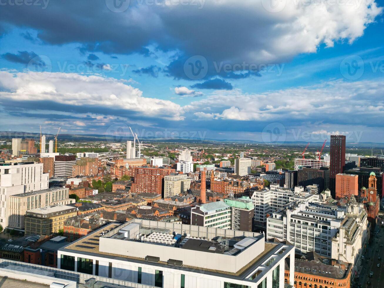 Iconic Buildings at Central Greater Manchester City Centre and Tall Buildings During Golden Hour of Sunset over England UK. Aerial Footage Was Captured with Drone's Camera on May 5th, 2024. photo