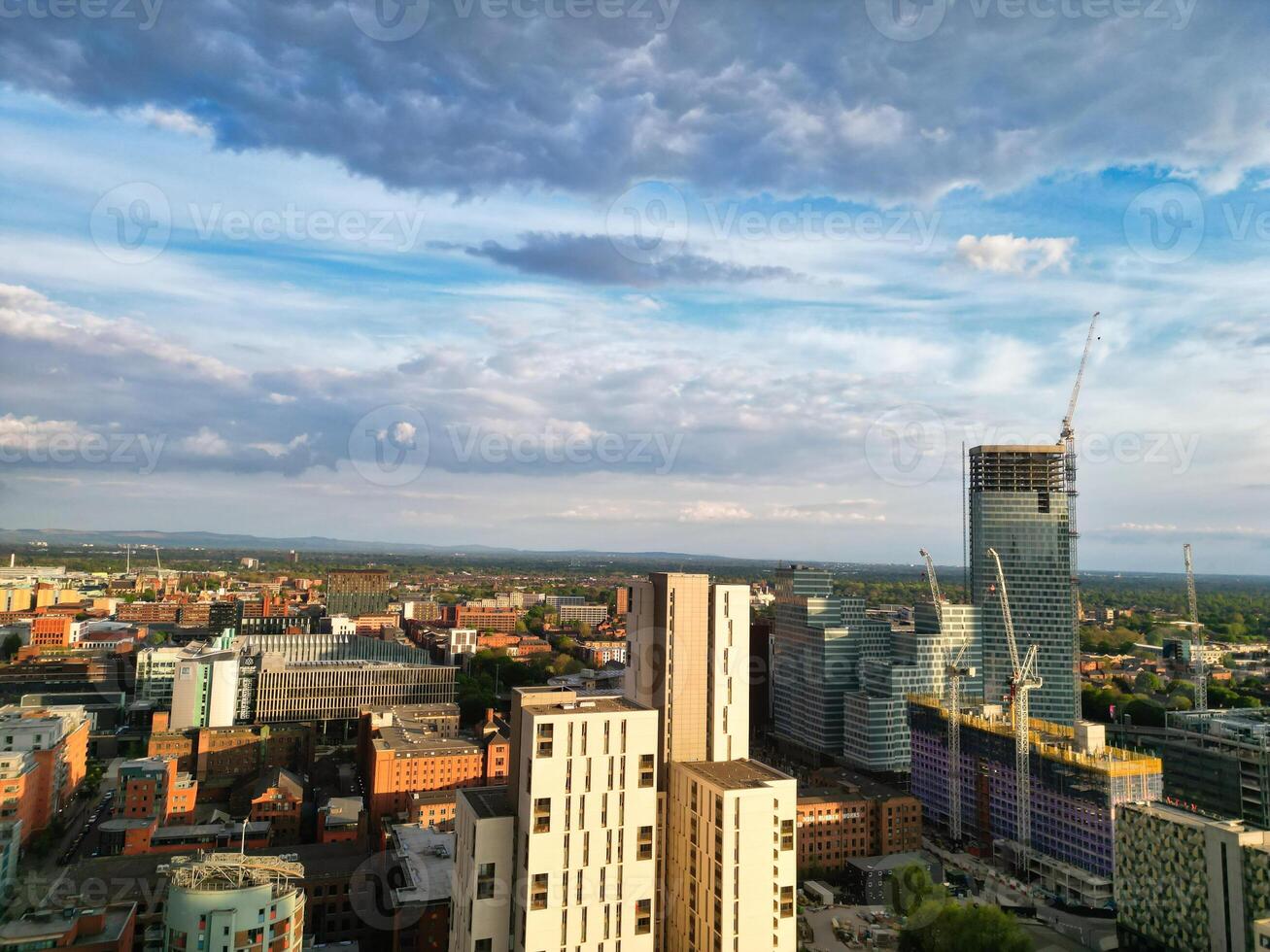 Iconic Buildings at Central Greater Manchester City Centre and Tall Buildings During Golden Hour of Sunset over England UK. Aerial Footage Was Captured with Drone's Camera on May 5th, 2024. photo