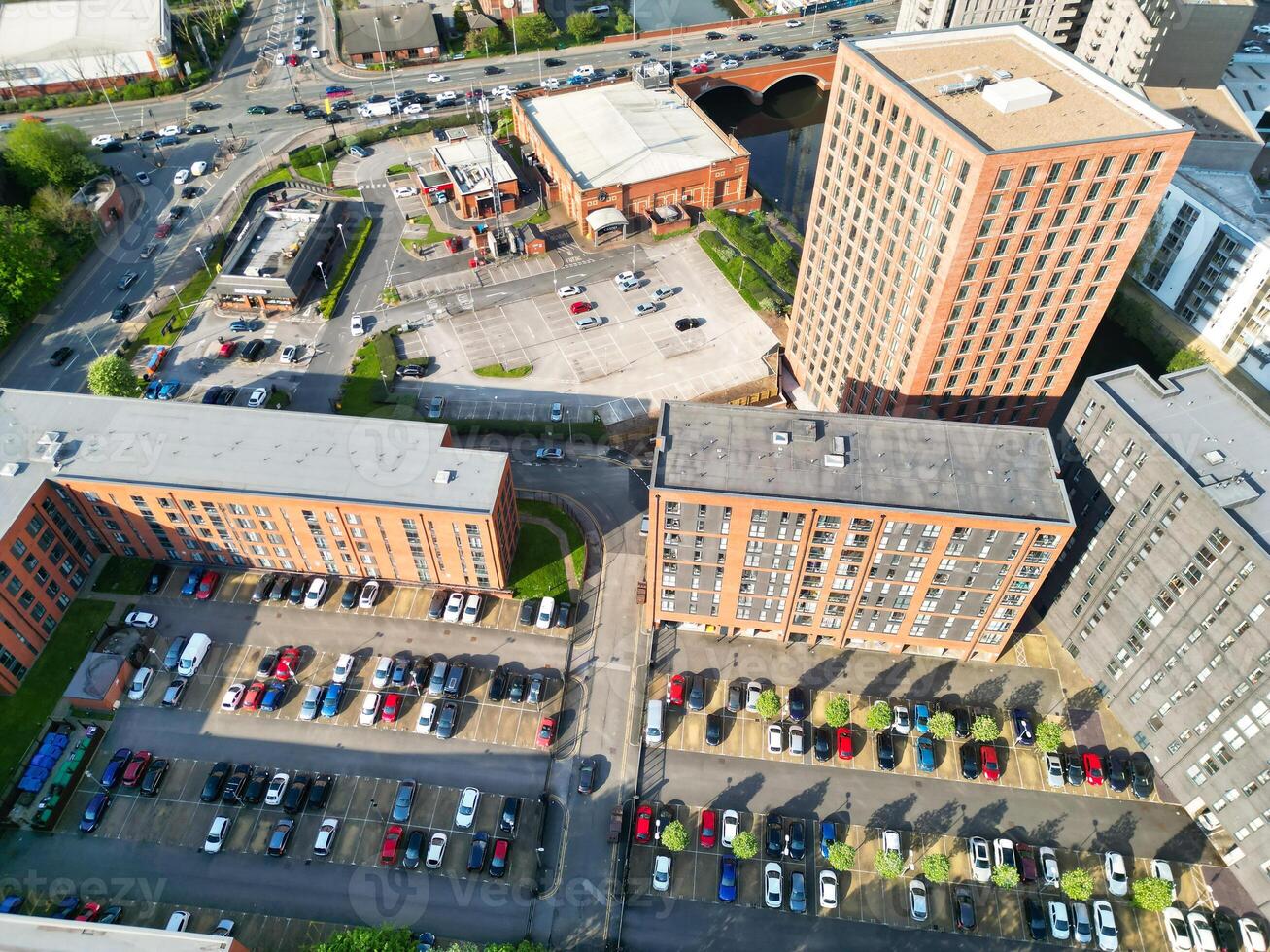 Iconic Buildings at Central Greater Manchester City Centre and Tall Buildings During Golden Hour of Sunset over England UK. Aerial Footage Was Captured with Drone's Camera on May 5th, 2024. photo