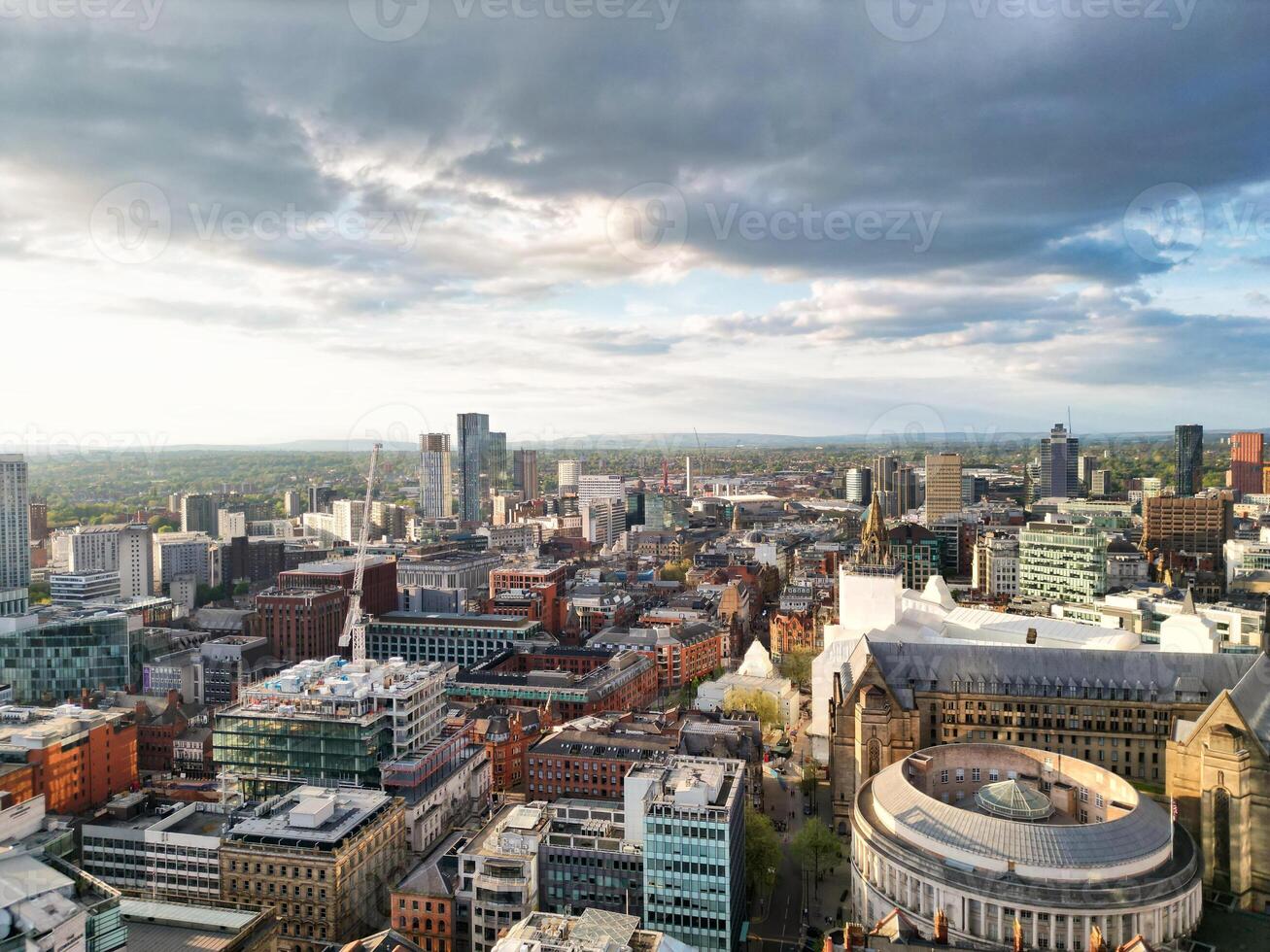 Iconic Buildings at Central Greater Manchester City Centre and Tall Buildings During Golden Hour of Sunset over England UK. Aerial Footage Was Captured with Drone's Camera on May 5th, 2024. photo