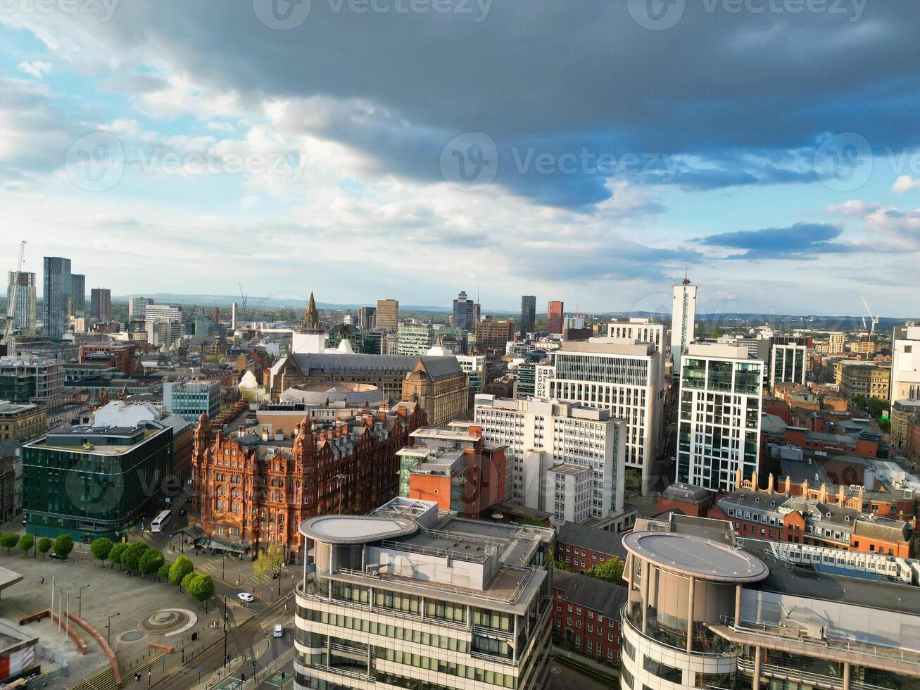 Iconic Buildings at Central Greater Manchester City Centre and Tall Buildings During Golden Hour of Sunset over England UK. Aerial Footage Was Captured with Drone's Camera on May 5th, 2024. photo