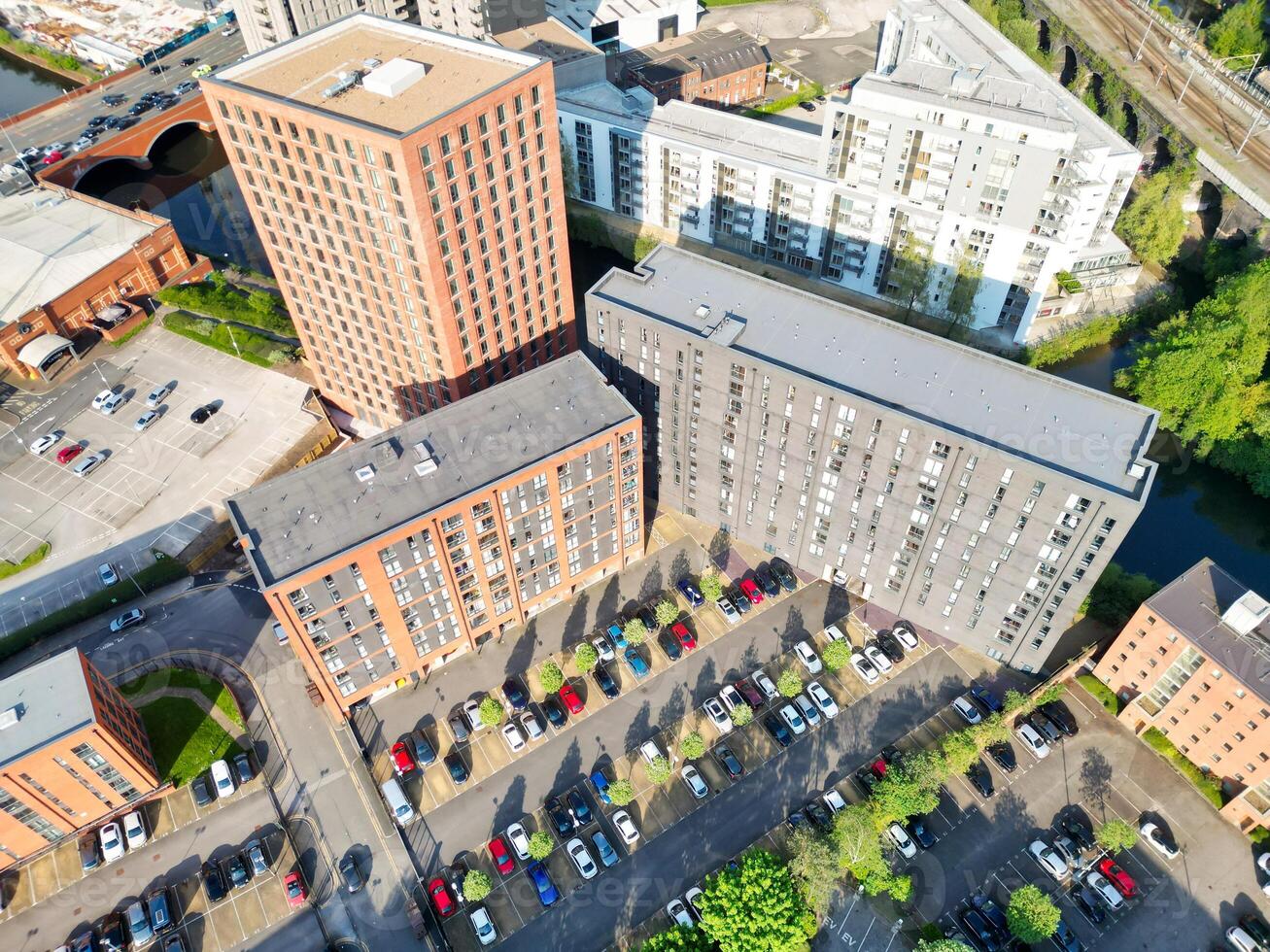 Iconic Buildings at Central Greater Manchester City Centre and Tall Buildings During Golden Hour of Sunset over England UK. Aerial Footage Was Captured with Drone's Camera on May 5th, 2024. photo