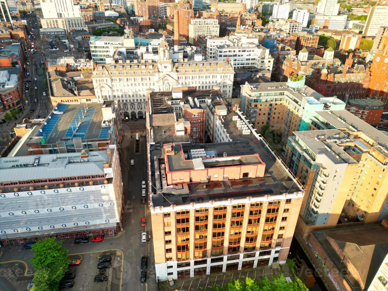 Iconic Buildings at Central Greater Manchester City Centre and Tall Buildings During Golden Hour of Sunset over England UK. Aerial Footage Was Captured with Drone's Camera on May 5th, 2024. photo