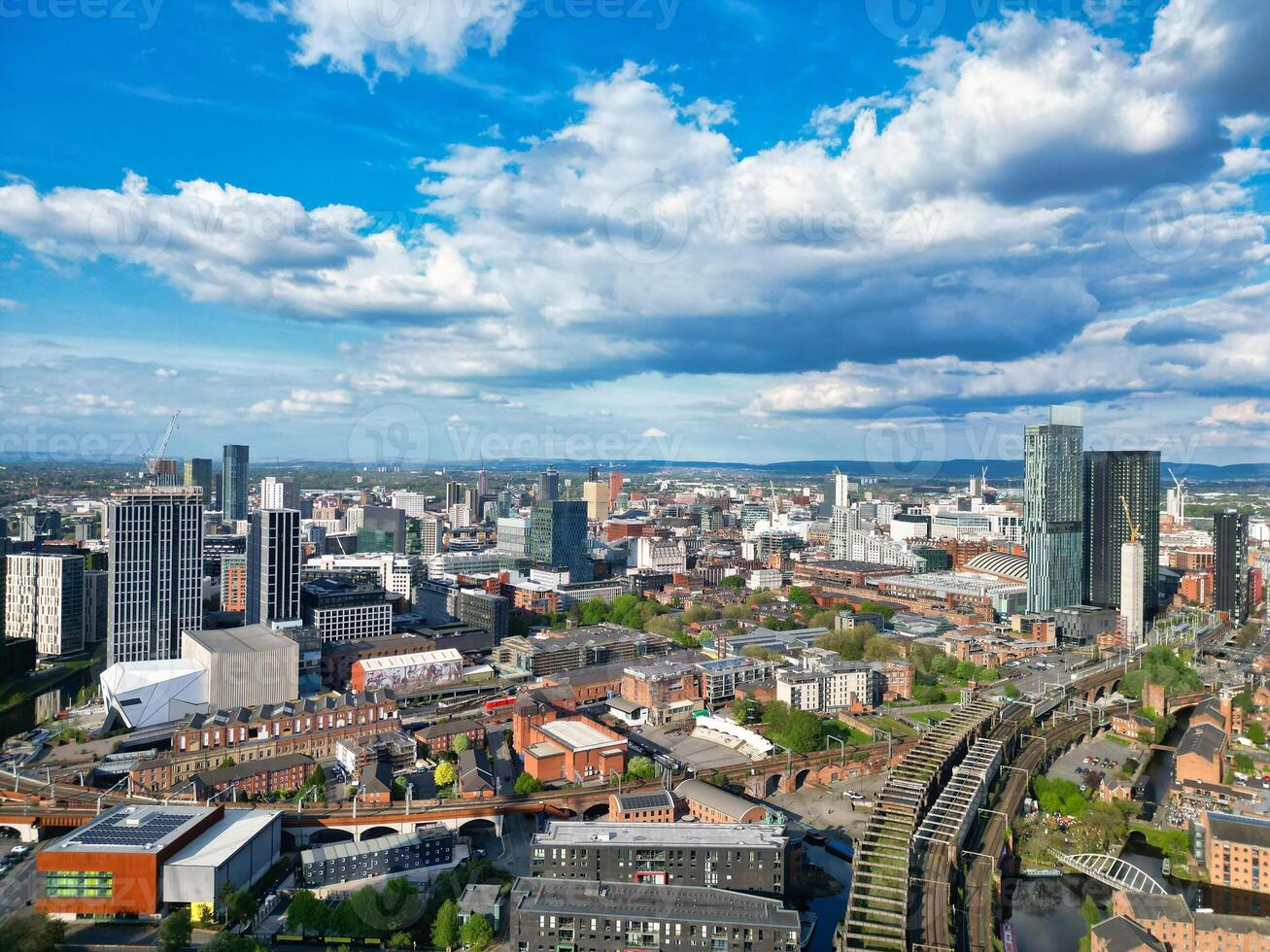 Iconic Buildings at Central Greater Manchester City Centre and Tall Buildings During Golden Hour of Sunset over England UK. Aerial Footage Was Captured with Drone's Camera on May 5th, 2024. photo