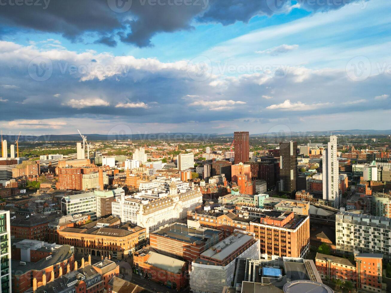 Iconic Buildings at Central Greater Manchester City Centre and Tall Buildings During Golden Hour of Sunset over England UK. Aerial Footage Was Captured with Drone's Camera on May 5th, 2024. photo