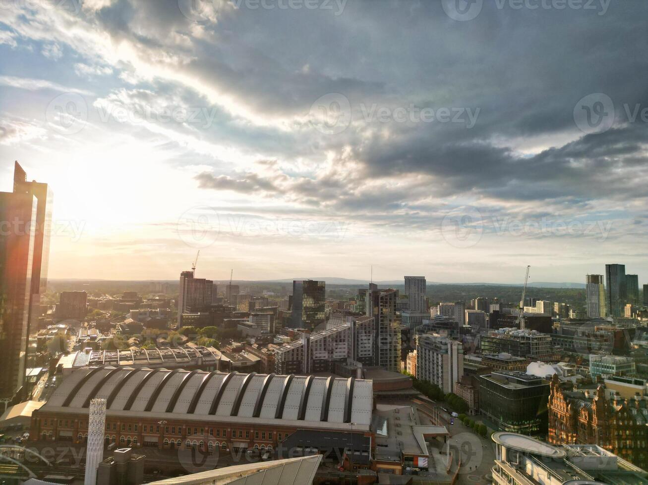 Iconic Buildings at Central Greater Manchester City Centre and Tall Buildings During Golden Hour of Sunset over England UK. Aerial Footage Was Captured with Drone's Camera on May 5th, 2024. photo