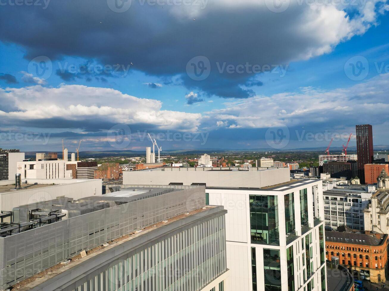Iconic Buildings at Central Greater Manchester City Centre and Tall Buildings During Golden Hour of Sunset over England UK. Aerial Footage Was Captured with Drone's Camera on May 5th, 2024. photo