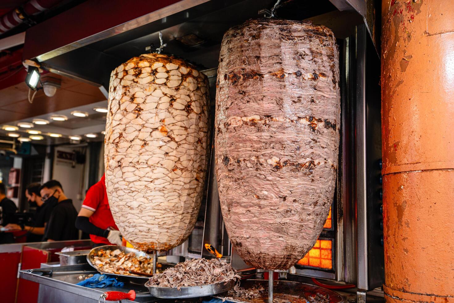 Kuala Lumpur, MALAYSIA - January 29, 2024. chef preparing and making Traditional Turkish Doner Kebab meat. It also knowns as Shawarma.It is a one of the famous street food in Bukit Bintang. photo