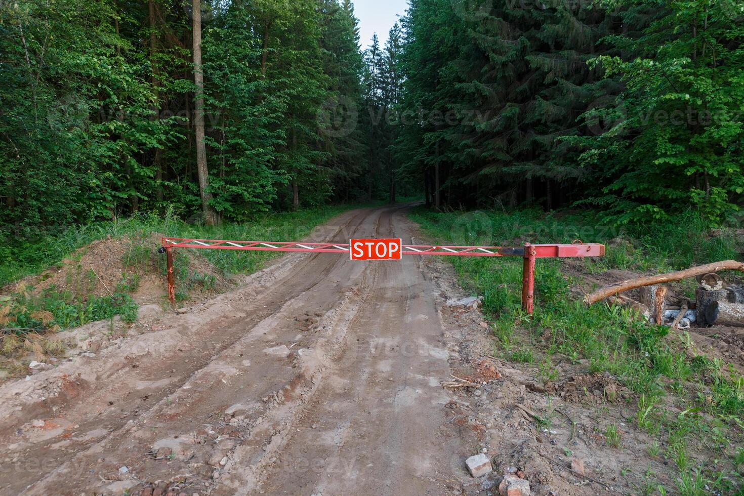 Stop sign in the forest. Road closed barrier in the forest. photo