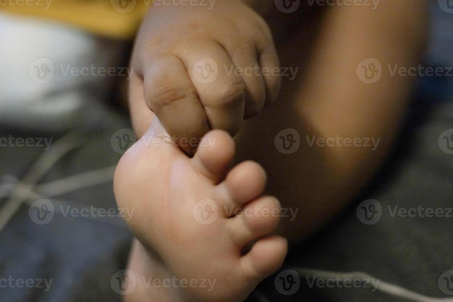 The Child Holds His Toes photo