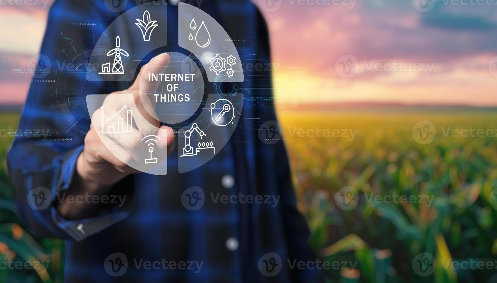 Man holding a virtual button with icons of agriculture and technology photo