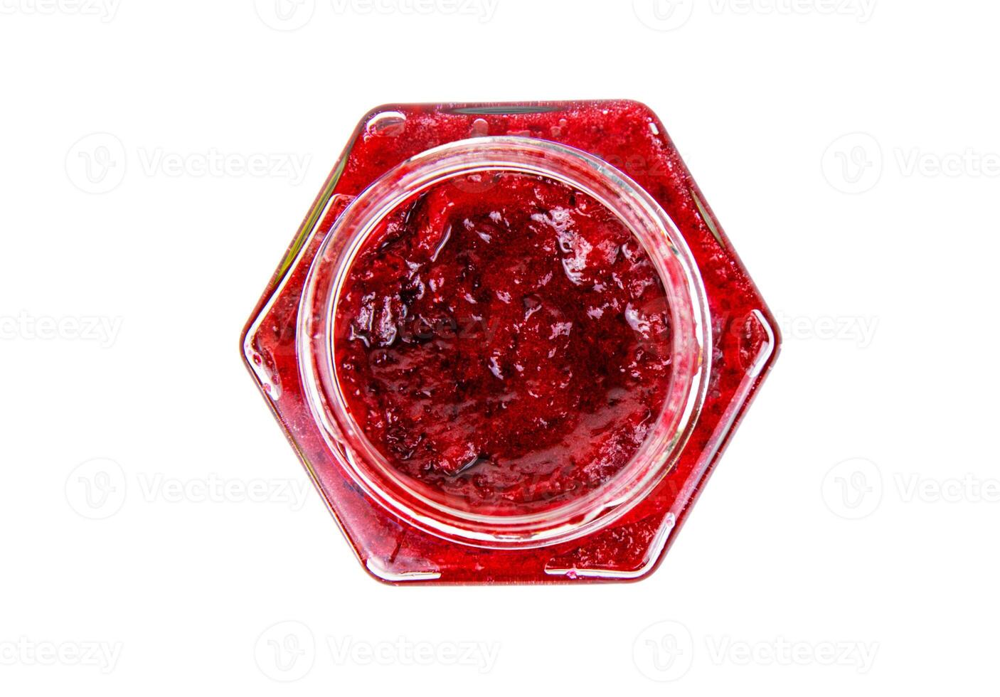 Top view of fresh, vibrant red currant berry jam in an open glass jar, perfect for breakfast spreads or desserts. Closeup. Copy space. Isolated on white background. photo