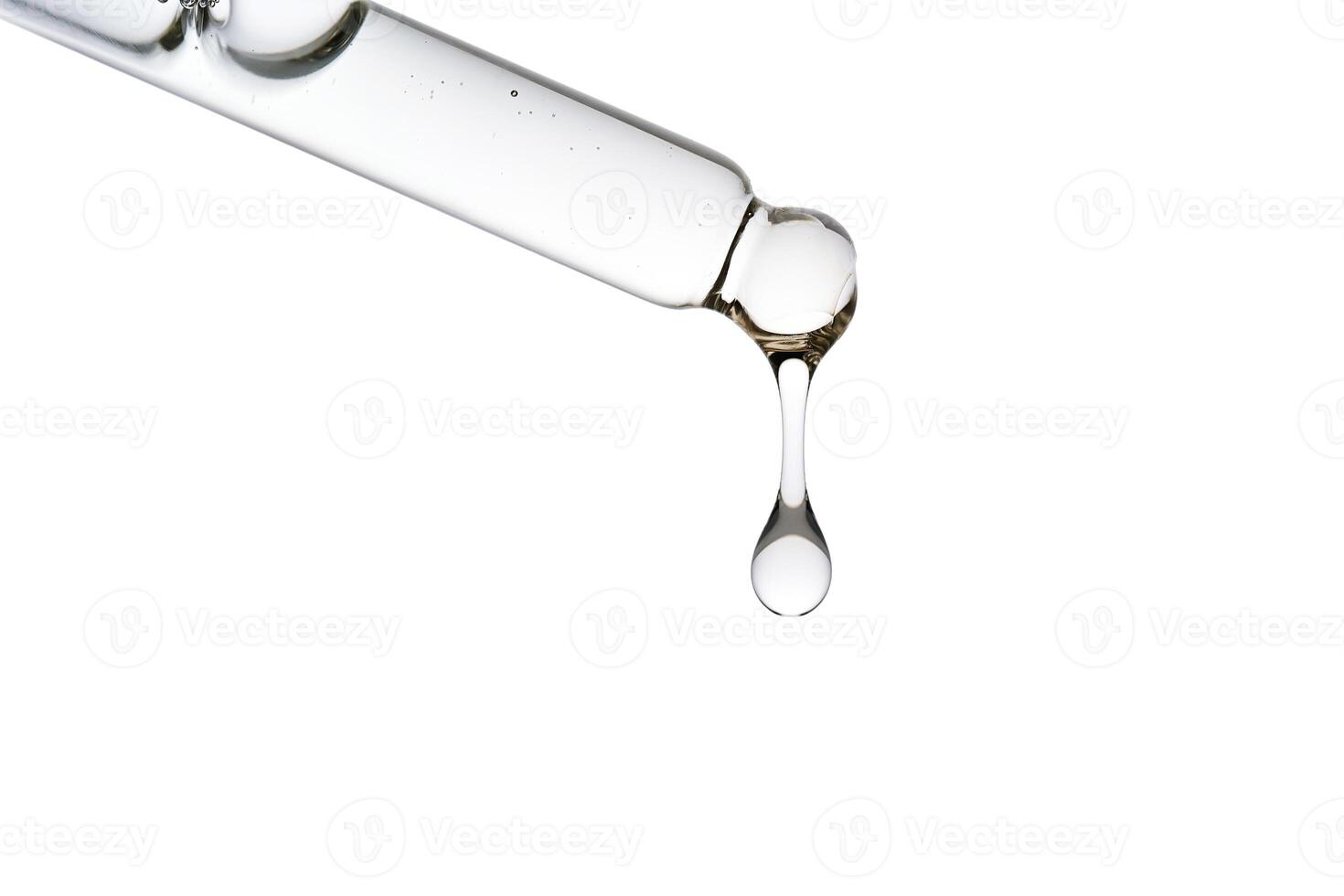Dropper pipette with delicious serum with bubbles close-up. photo